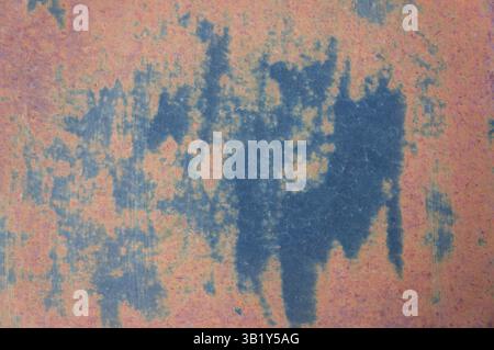 Rusty iron sheet featuring blue stains, creating an intriguing abstract texture that captures the essence of decay and weathered beauty Stock Photo