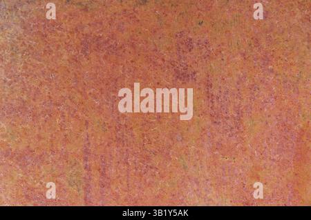 Close up view of a rusty iron sheet, highlighting the texture and color variations caused by corrosion and oxidation, suitable for backgrounds and tex Stock Photo