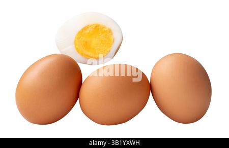 Front view of raw brown chicken eggs and cooked or boiled chicken egg with egg yolk in half in stack is isolated on white background. Stock Photo