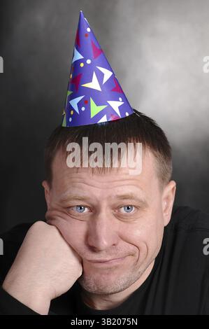 A sad man in the festive hood Stock Photo