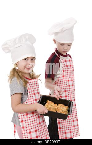 Two children in the chef's hat isolated on white background Stock Photo