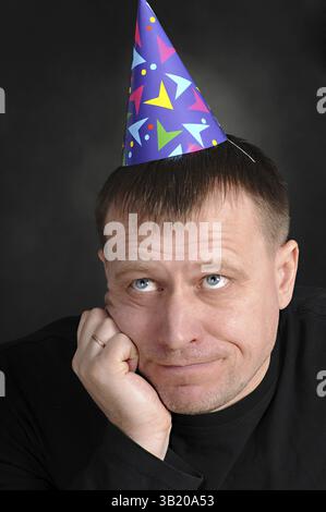 A sad man in the festive hood Stock Photo
