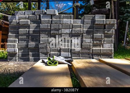 Gray granite cubes stacked in the garden, preparation for laying tiles and cubes on the veranda in the garden Stock Photo