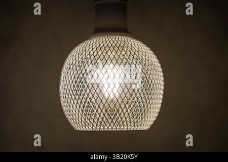 patterned light chandelier with light bulb on dark background Stock Photo