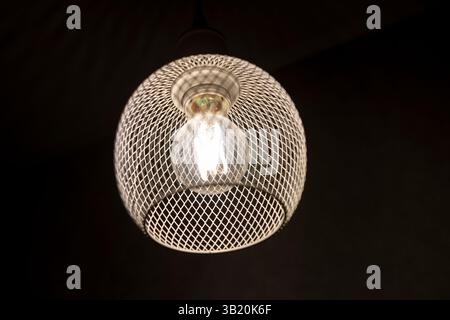 patterned light chandelier with light bulb on dark background Stock Photo