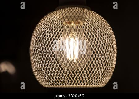 patterned light chandelier with light bulb on dark background Stock Photo