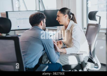 Colleagues discussing project at modern office desk Stock Photo