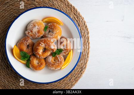 Spanish fried anise doughnuts. Top view table with christmas decorations. Stock Photo