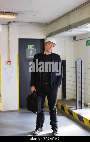 Supervisor in a white hard hat during inspection at a modern facility. Engineering and planning Stock Photo