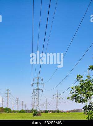 High voltage transmission towers under a blue sky Stock Photo - Alamy