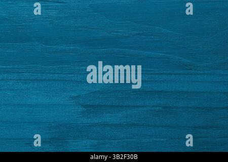 Blue painted wooden board background. Blue rough wooden surface with grain. Stock Photo