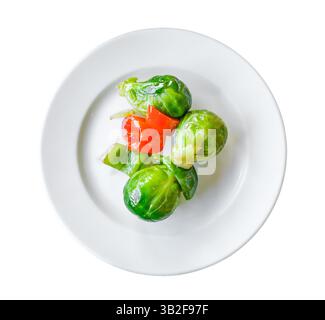 grilled brussels sprouts on plate, top view, isolated on white background with clipping path Stock Photo