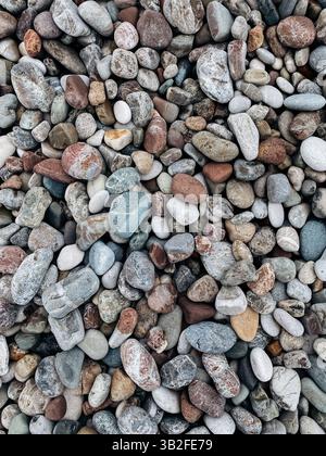 Smooth multicolored pebbles and stones creating natural texture on a beach in Antalya, Turkey. Stock Photo