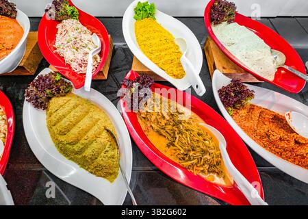 various salads and hummus on buffet table Stock Photo