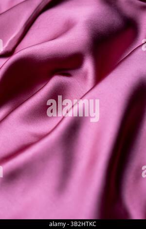 A gentle and elegant light pink cloth, reflecting light with a subtle gloss, perfect for fashion, photography, or home decor. Stock Photo