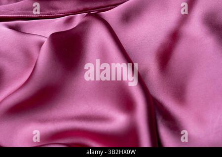 A light pink silky fabric that exudes elegance and grace, offering a soft, smooth surface that catches the light beautifully Stock Photo
