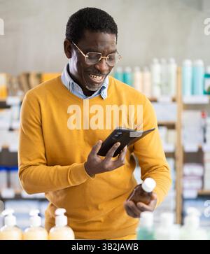 Adult man scanning qr code of syrup Stock Photo