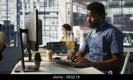 Data scientist developing and maintaining machine learning APIs solving complex problems. Man training predictive models capable of handling tasks such as language processing, camera B Stock Photo