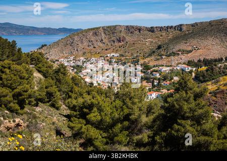 Aerial view of the main town on Hydra island in Greece, with red-roofed houses clustered around the port. Stock Photo