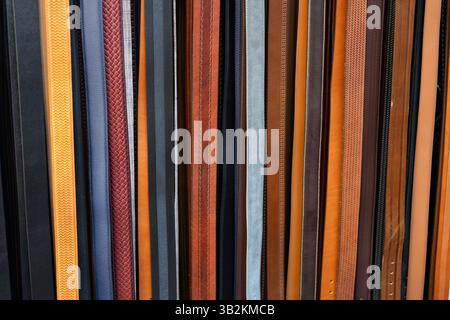 Colourful leather belts for use as a background texture Stock Photo
