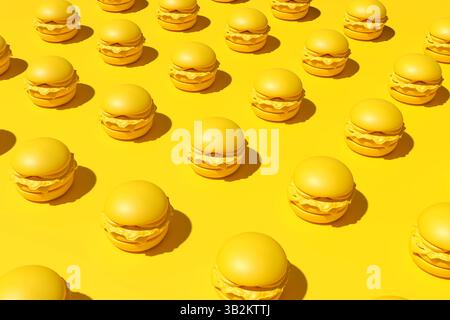 Many delicious burgers forming a repetitive pattern on a monotone yellow backdrop, creating a visually appealing image ideal for food and restaurant t Stock Photo
