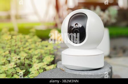 CCTV, security camera system operating with blurred image of sun light in garden background, surveillance security technology concept. Stock Photo