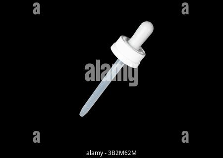 Pipette isolated on black background. Medical equipment.  Cosmetic medical pipette with a white cap Stock Photo