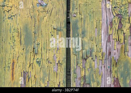 Old wood with cracked yellow green paint Stock Photo