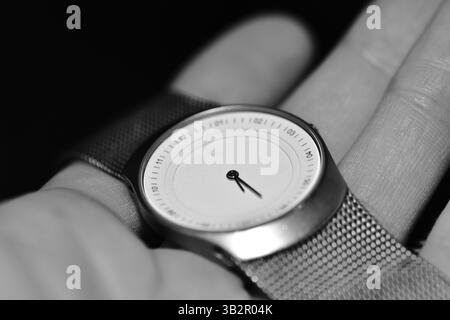 Hand watch in palm close up time concept black and white color Stock Photo