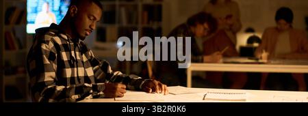 Focused Student Studying Foreign Languages at Nighttime Classroom Stock Photo