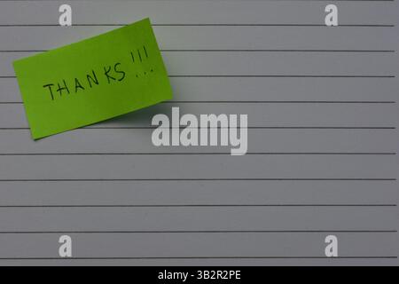 Message thanks thank you on green sticky note day on notebook line paper background Stock Photo