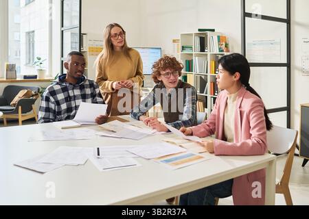 Studying Foreign Languages in Modern Classroom Setting Stock Photo