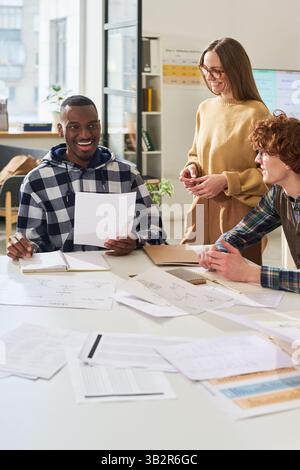 Discussing Foreign Language Projects in Classroom Setting Stock Photo