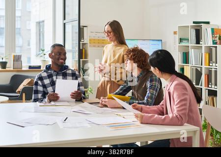 Smiling Students Learning Foreign Languages in Classroom Stock Photo