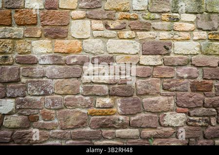 Old rustic wall made of brown stones. Stock Photo