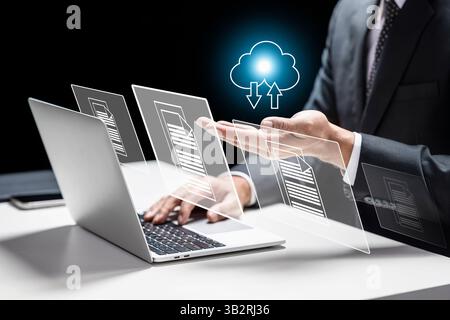 Businessman using a laptop while showing an icon of a cloud and files. Technology innovation on a virtual screen. Concept of data management system Stock Photo