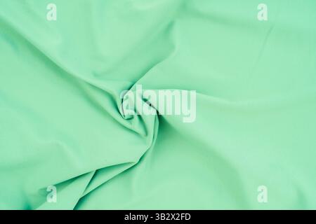 Green fabric with cotton texture, light green for backgrounds, textures, banners, slides and backgrounds. Stock Photo
