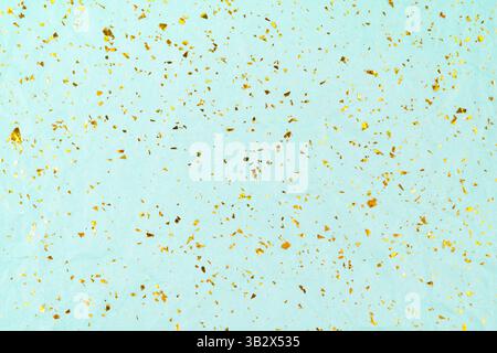 Golden glitter sparkles on blue holiday background. Festive backdrop for your projects. Stock Photo