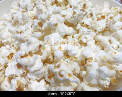 Detail of a bucket of freshly popped popcorn on the kitchen counter Stock Photo