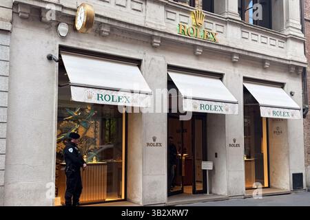 Milan, Italy - April, 08, 2025: Rolex boutique storefront with branded awnings and security guard on Via Montenapoleone. Milan luxury shopping Stock Photo