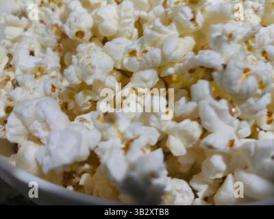 Detail of a bucket of freshly popped popcorn on the kitchen counter Stock Photo