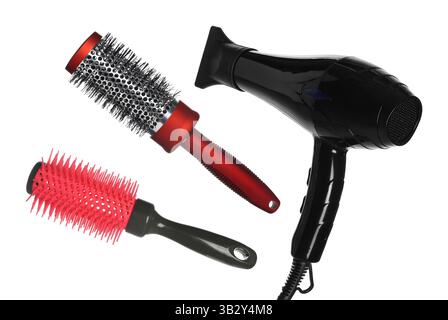 Hair dryer and round brushes in air on white background, collage Stock Photo