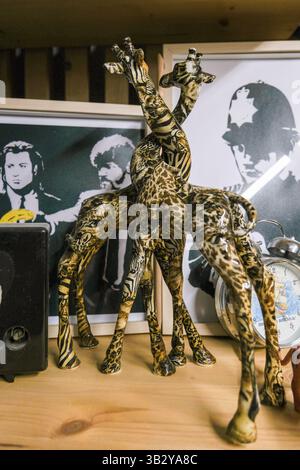 Moscow, Russia, 14.07.2025 Figure of hugging giraffes stands on book shelf Stock Photo