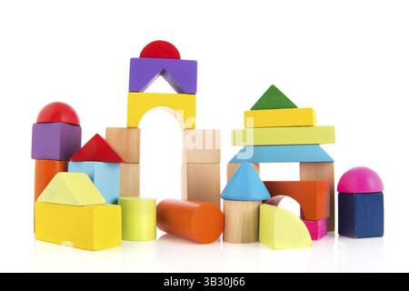 Building made from wooden toy blocks isolated over white background Stock Photo
