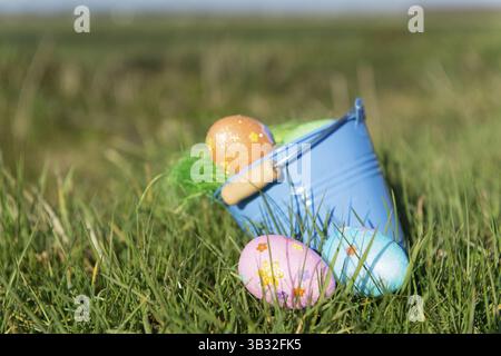 Bucket with chocolate easter eggs outdoor in the garden Stock Photo