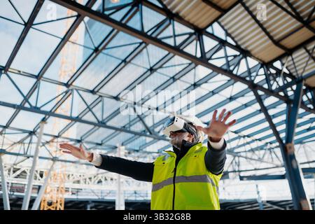 Engineer using virtual reality to inspect building progress. Stock Photo