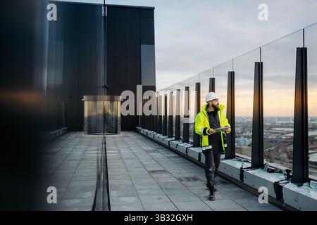 Construction site manager using digital tablet to inspect building progress. Stock Photo