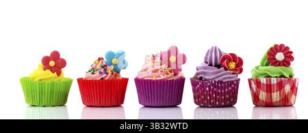 Row colorful cupcakes with buttercream flowers and confetti Stock Photo