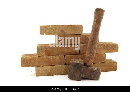 Bricks and hammerto build a wall or making pavement Stock Photo