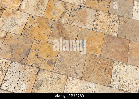 A close-up view of a stone tiled surface showcasing rustic textures and earthy tones. Perfect as a background or material reference for interior desig Stock Photo